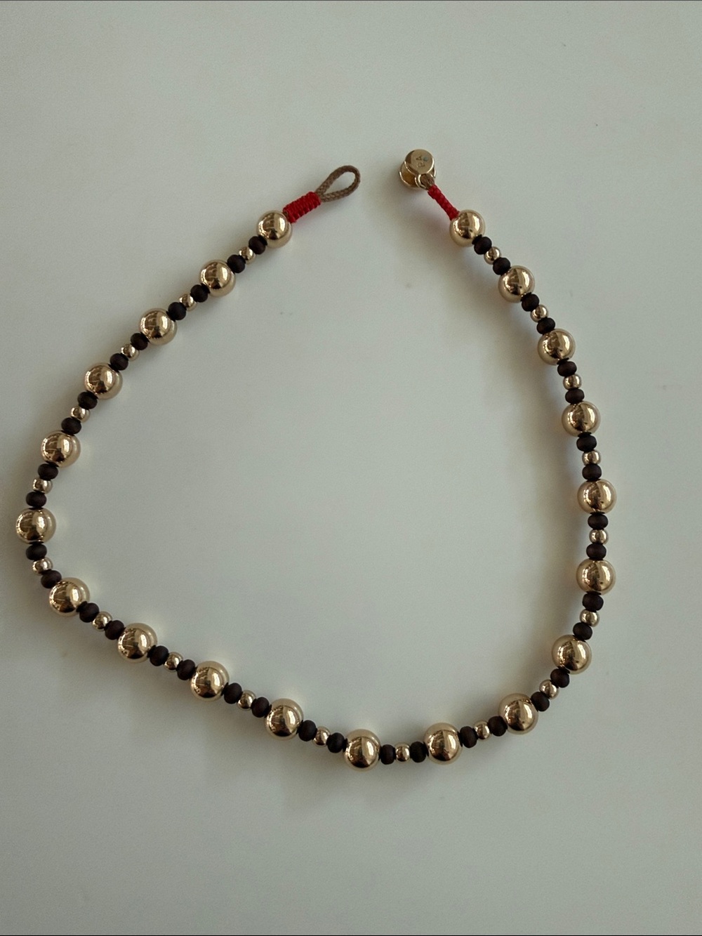 Roxanne Assoulin Gold and Brown Beaded Necklace with Red Accent 14” length
